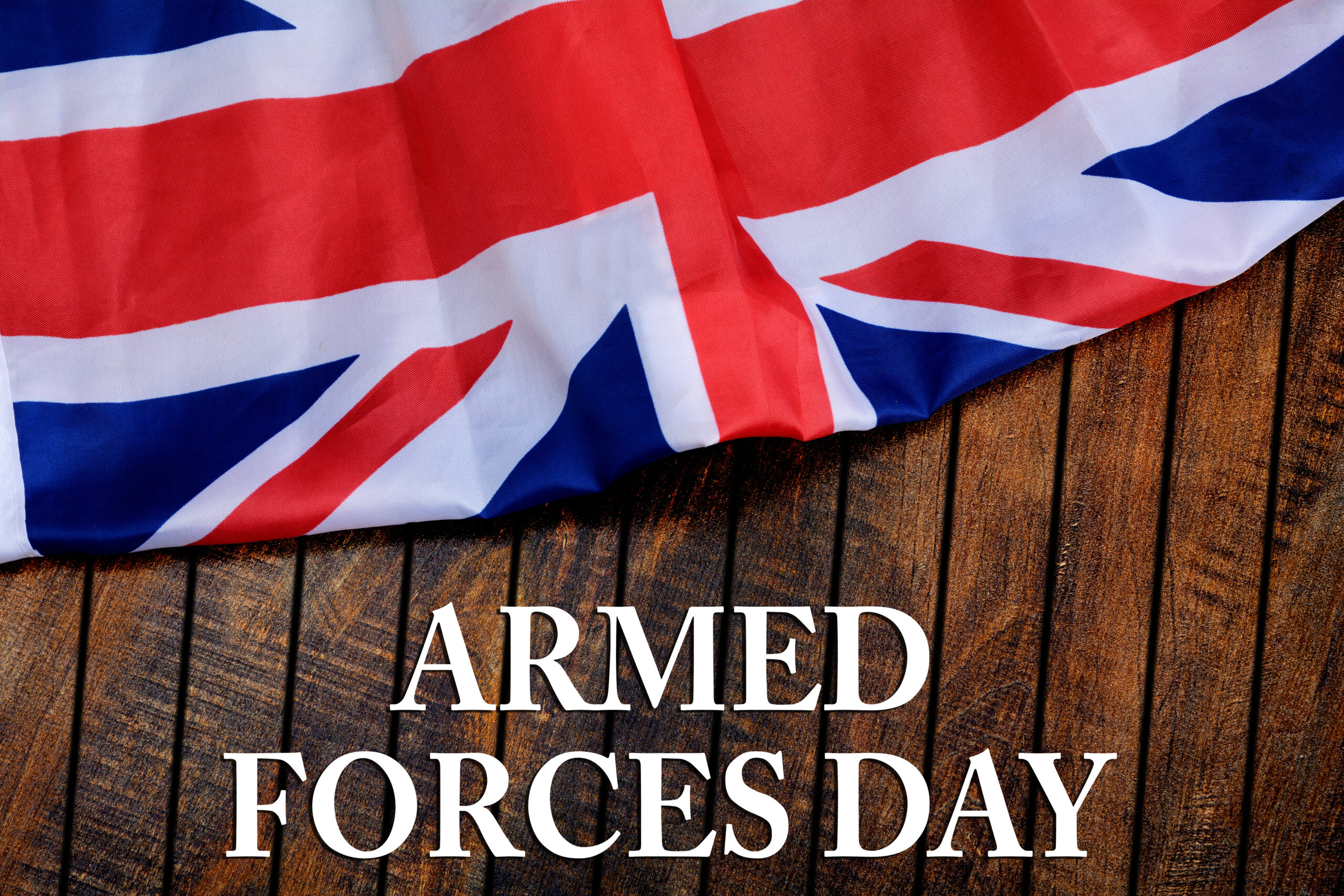 Armed forces day on wooden background - flag of the United Kingdom UK