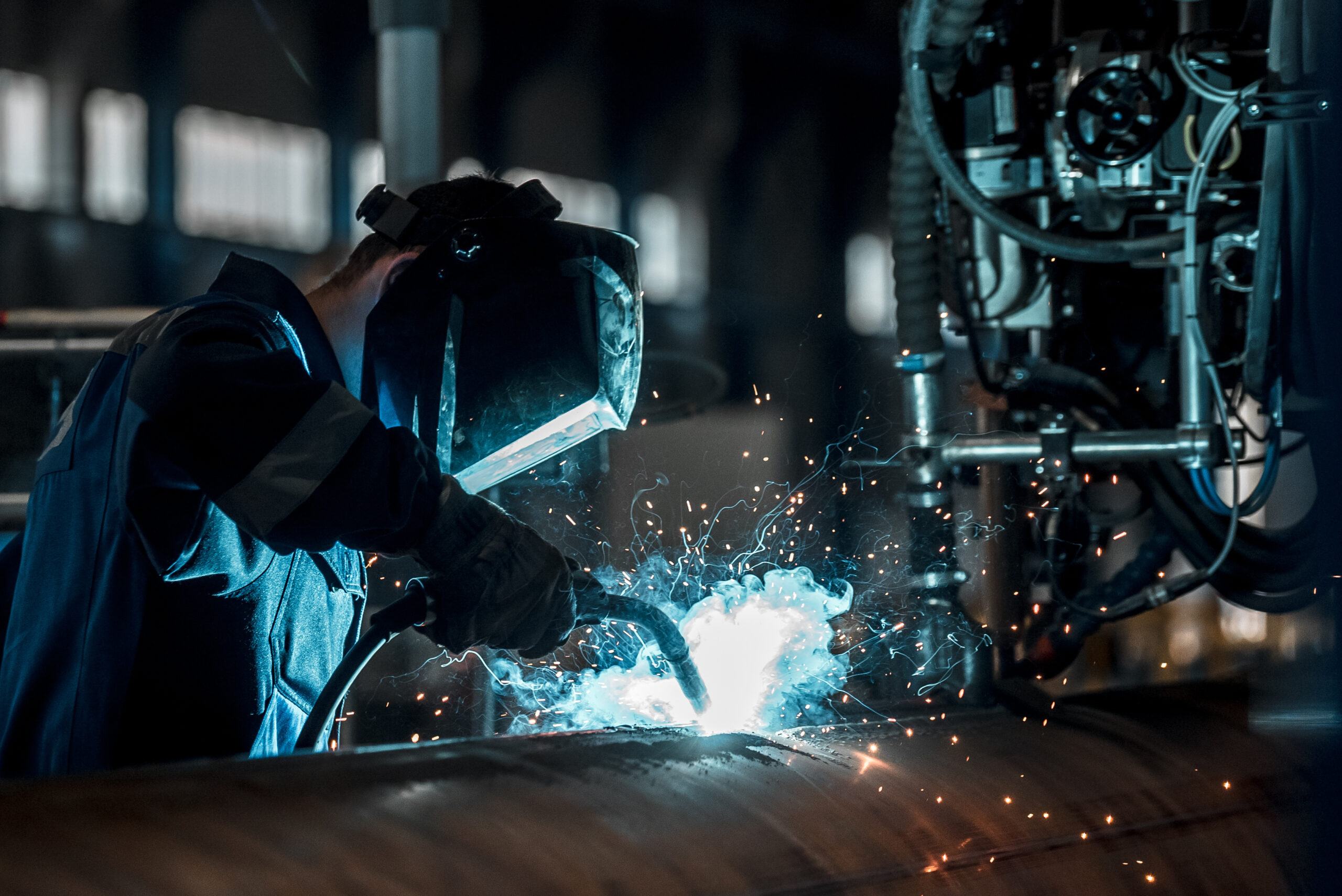 man welds at the factory